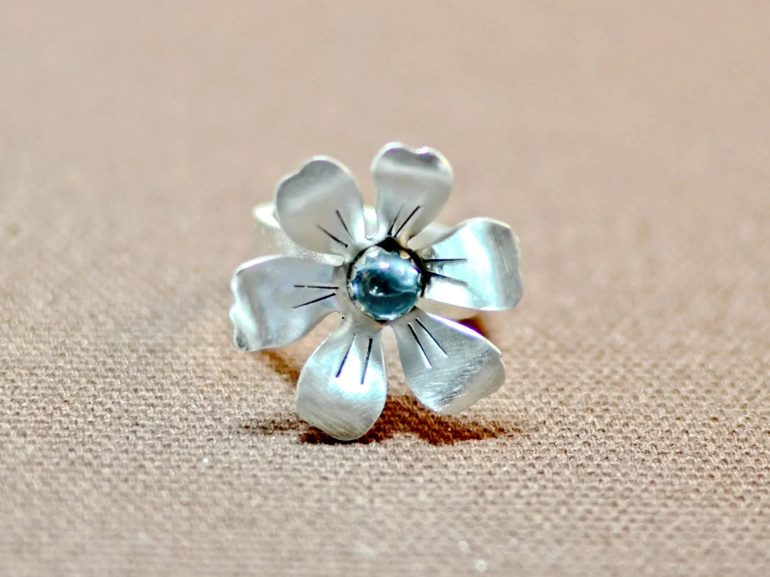 Flower shaped sterling silver ring with blue topaz