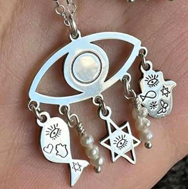 Sterling Silver Charms of Israel hanging on the protection symbol eye. Fish, Star of David, Hamsa.